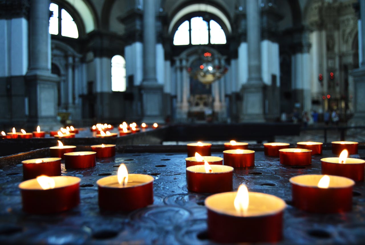 Candlelit ambiance in a historic Venetian church, featuring intricate architecture and serene lighting.